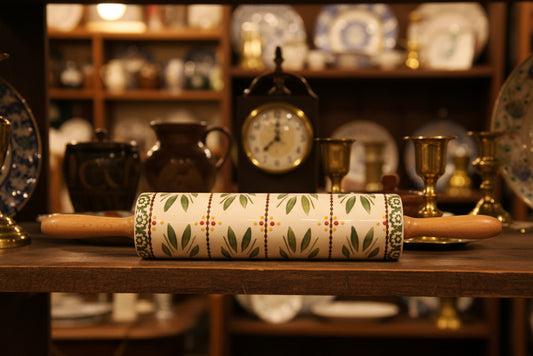 Decorative rolling pin with a pattern on a green satin surface