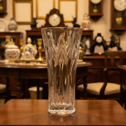 Clear glass vase on a green satin surface
