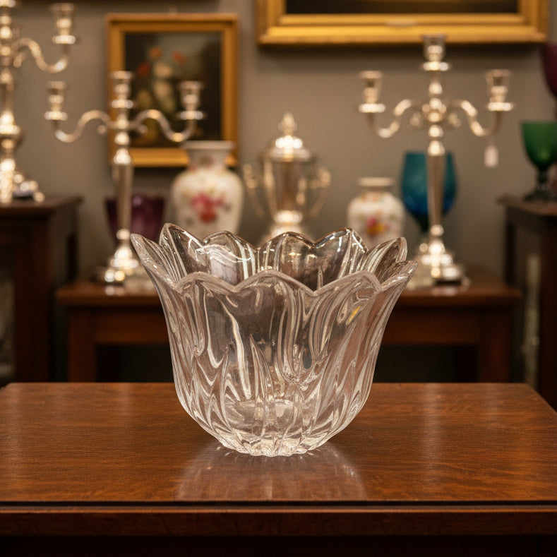 Clear glass bowl on a green satin surface